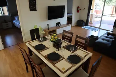 a dining room table with chairs and a television at Relax private Pool Villas - 4 bedroom villas in Ao Nang Beach