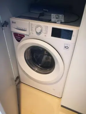 a washing machine with a laptop on top of it at Emerald Terrace Resort in Patong Beach