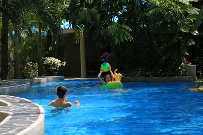 a group of people in a swimming pool at Naka Resort in Kamala Beach