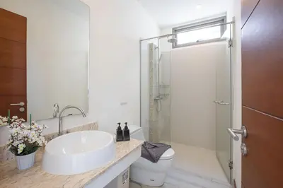 a white bathroom with a sink and a shower at VILLA Bangka 4BR Private pool villa Rawai in Rawai Beach