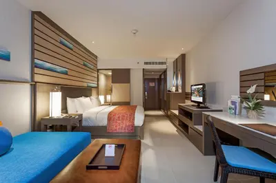 a hotel room with a bed and a desk at Holiday Inn Resort Phuket, an IHG Hotel in Patong Beach
