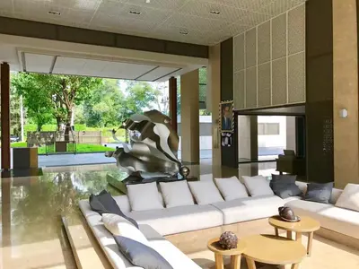 a living room with white couches and a statue at Baan Mai Khao in Mai Khao Beach
