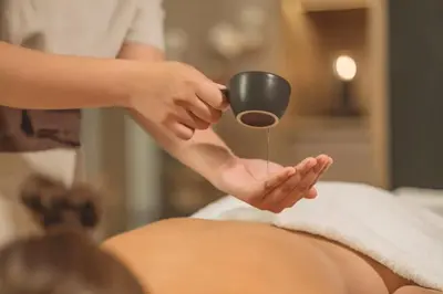 a woman getting a foot massage with a cup at Twinpalms MontAzure Phuket in Kamala Beach