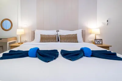 a bedroom with a large bed with blue pillows at Prime Patong-5BR-6BR pool villa See photo BEFORE BOOK in Patong Beach