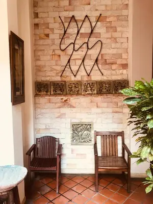 two chairs sitting in front of a brick fireplace at Seeka Boutique Resort in Patong Beach
