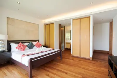 a bedroom with a bed with red pillows at Pearl of Naithon in Nai Thon Beach