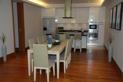 a kitchen and dining room with a table and chairs at Pearl of Naithon in Nai Thon Beach