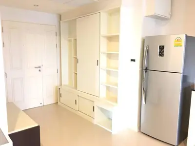 a kitchen with a refrigerator and white cabinets at WOW Apartment at Unity Patong in Patong Beach