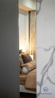 a bedroom with a bed and a mirror at Enjoy Sunset Rainbow Alley - WOW Townhouse at Patong Hill in Patong Beach