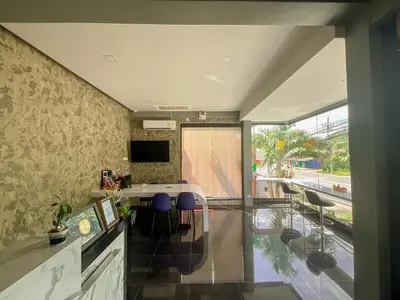 a dining room with a table and chairs at Tall Tree Kata Phuket in Kata Beach