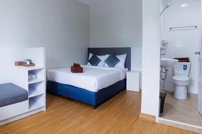a bedroom with a bed and a sink and a toilet at Silla Patong Boutique - Beach Walk Access in Patong Beach