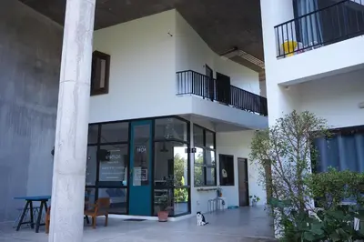 a cat is standing outside of a building at Baan Trok Bedroom Studio Maikhao in Mai Khao Beach