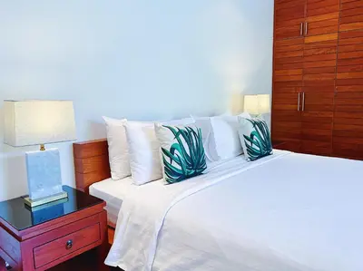 a bedroom with a bed and a night stand with a lamp at Beautiful 3br 380sqm Pool Villa Walk To Bangtao Beach and Catch club in Bang Tao Beach