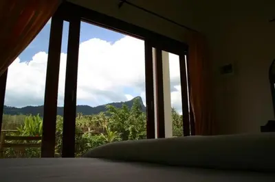 a bedroom with a window with a view of a mountain at Naga Peak Resort in Ao Nang Beach