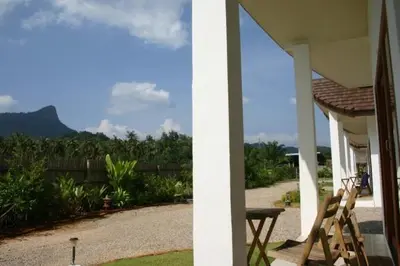a porch of a house with a table and chairs at Naga Peak Resort in Ao Nang Beach