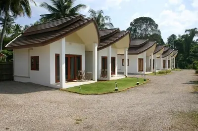 a row of houses with grass in front of them at Naga Peak Resort in Ao Nang Beach