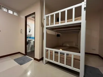 a bunk bed in a room with a mirror at Sabai House in Phi Phi Don