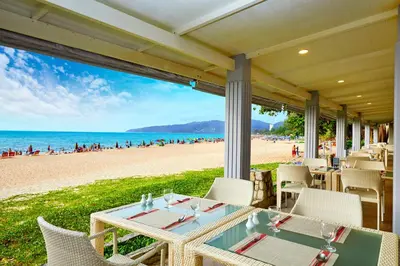 a table on the beach with a view of the beach at Beyond Karon in Karon Beach