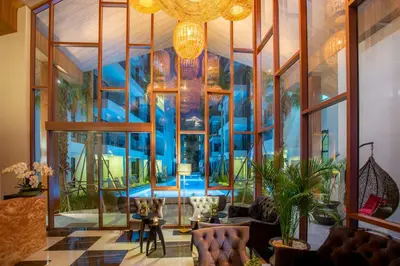 a large room with a pool inside of a building at Surin Beach Residence - Official Account in Surin Beach