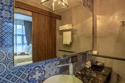 a bathroom with a sink and a mirror at Surin Beach Residence - Official Account in Surin Beach