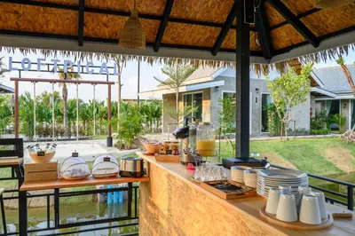 an outdoor kitchen with a counter with food on it at Loftpical Resort in Phuket Town