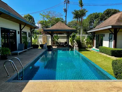 a swimming pool in front of a house at 3bdr Pool villa Naiharn KOK by Capital Pro in Rawai Beach