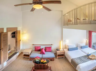 a bedroom with two beds and a ceiling fan at Chada Thai Village in Ao Nang Beach