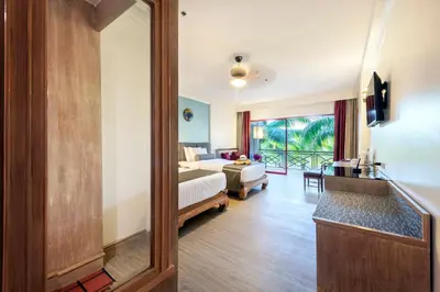 a hotel room with a bed and a living room at Chada Thai Village in Ao Nang Beach