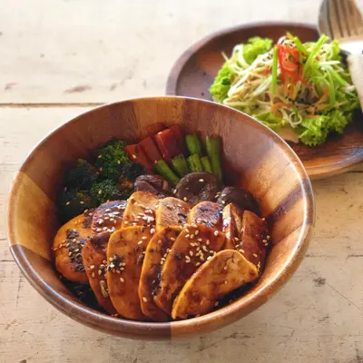 a bowl of food with meat and vegetables on a table at Jaiyen Eco Resort in Ko Yao Noi