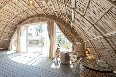 a room with a guitar and a chair in a room at Jaiyen Eco Resort in Ko Yao Noi