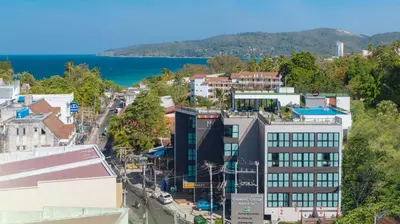 an aerial view of a city with a lake at KK Karon Kata Boutique Hotel in Kata Beach