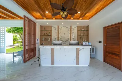a kitchen with a center island with a ceiling fan at Poonsiri Varich Pool Villa Aonang in Ao Nang Beach