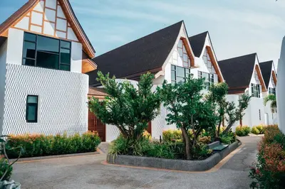 a row of houses with trees in a courtyard at Poonsiri Varich Pool Villa Aonang in Ao Nang Beach