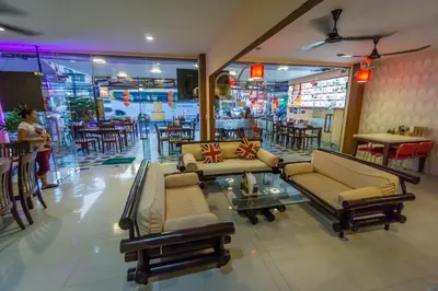 a lobby with couches and tables in a restaurant at Mellow Space Boutique Rooms in Karon Beach