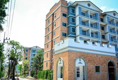 a tall brick building with a blue at The Title Residence NaiYang in Nai Yang Beach