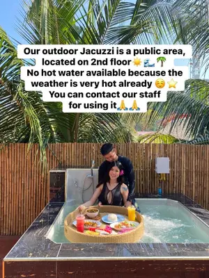 a man and a woman sitting in a hot tub at Phi Phi Maiyada Resort in Phi Phi Don