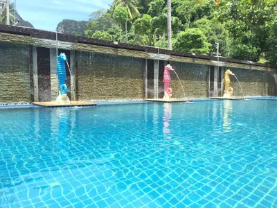 a group of people playing in a swimming pool at Phi Phi Maiyada Resort in Phi Phi Don