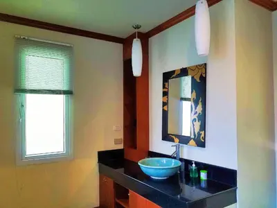 a bathroom with a bowl sink and a mirror at Thai Family karon Pool Villa \u6cf0\u5982\u5bb6\u5361\u4f263\u5367\u6cf3\u6c60\u522b\u5885 in Karon Beach