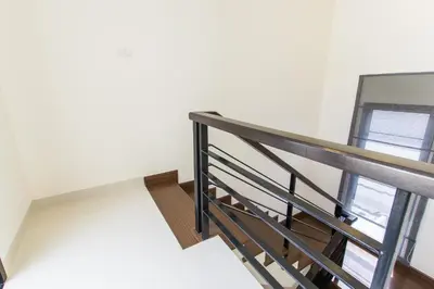 a staircase in a house with two windows at 5bdr Pool Villa In Laguna Park #40 by Capital Pro in Bang Tao Beach