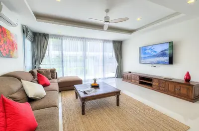 a living room with a couch and a tv at 5bdr Pool Villa In Laguna Park #40 by Capital Pro in Bang Tao Beach