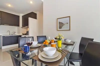 a dining room with a table with glasses of wine at Chic Condo by RESAVA in Karon Beach