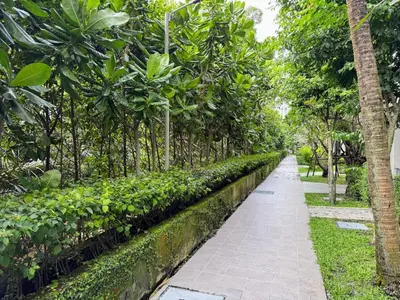 a walkway in a park with trees and plants at The Title Residencies Naiyang by Beringela in Nai Yang Beach