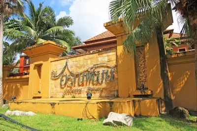 a yellow building with a painting on the side of it at Rudi House in Patong Beach