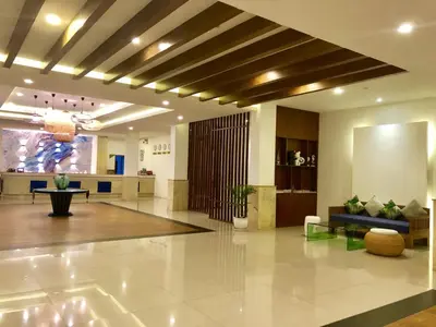 a lobby with a couch and a table at Blue Beach Grand Resort And Spa in Rawai Beach