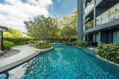 a swimming pool in front of a building at Apartment at Aristo Surin by Lofty in Surin Beach