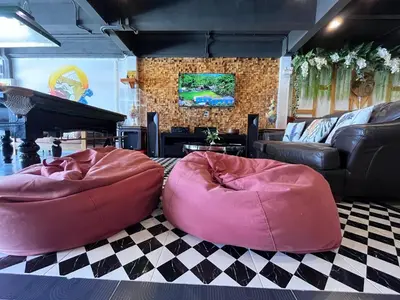 two large bean bags on the floor in a living room at Hanuman VIP Hostel in Bang Tao Beach