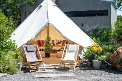 two chairs and a tent in a yard at Roost Glamping - SHA Certified in Rawai Beach