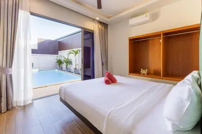 a bedroom with a large bed and a swimming pool at New Boutique Pool Villa Sequoia Close to Rawai and Naiharn Beach in Rawai Beach