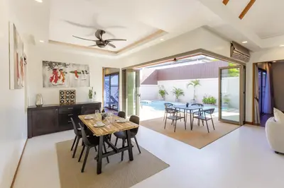 a dining room and living room with a table and chairs at New Boutique Pool Villa Sequoia Close to Rawai and Naiharn Beach in Rawai Beach
