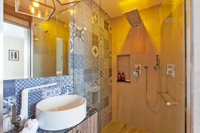 a bathroom with a sink and a shower at Palmyrah Surin Apartments by Beringela in Surin Beach